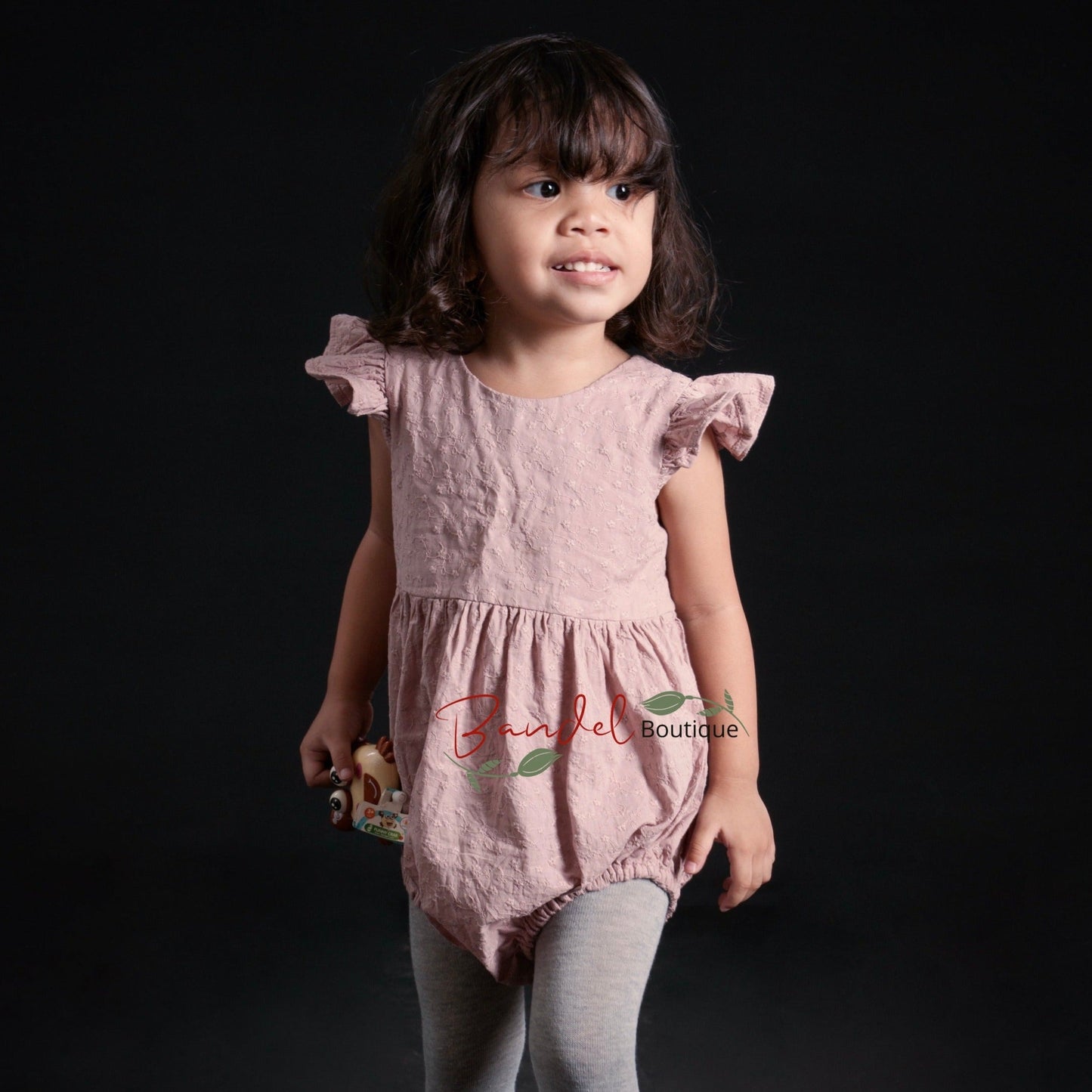 old-rose Flutter Sleeve Embroidery Romper is crafted from soft, breathable cotton, making it an ideal outfit for your little one. It features flutter sleeves, elastic at the leg opening, wooden buttons at the back and snaps at the crotch for easy diaper changes. Comfort and convenience – the perfect combination.
