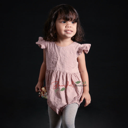 old-rose Flutter Sleeve Embroidery Romper is crafted from soft, breathable cotton, making it an ideal outfit for your little one. It features flutter sleeves, elastic at the leg opening, wooden buttons at the back and snaps at the crotch for easy diaper changes. Comfort and convenience – the perfect combination.