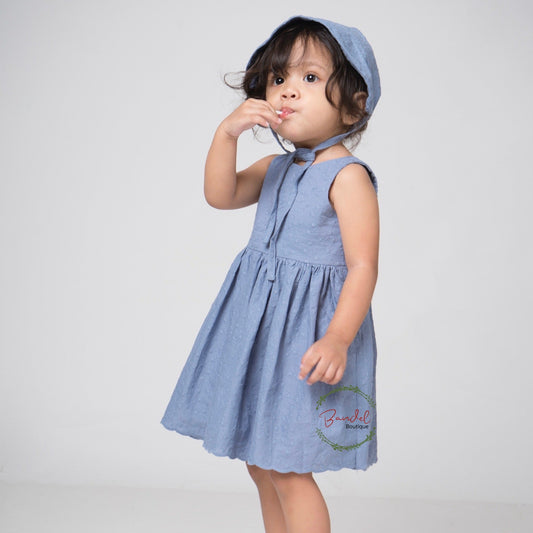 Blue Embroidery Cotton Dress features a simple front bodice with two rows of elastic banding and a large opening with bow-ties at the back for comfort and a timeless effect. The knee-length full skirt is crafted from 100% cotton and ensures a comfortable fit. This dress is perfect for any special occasion.