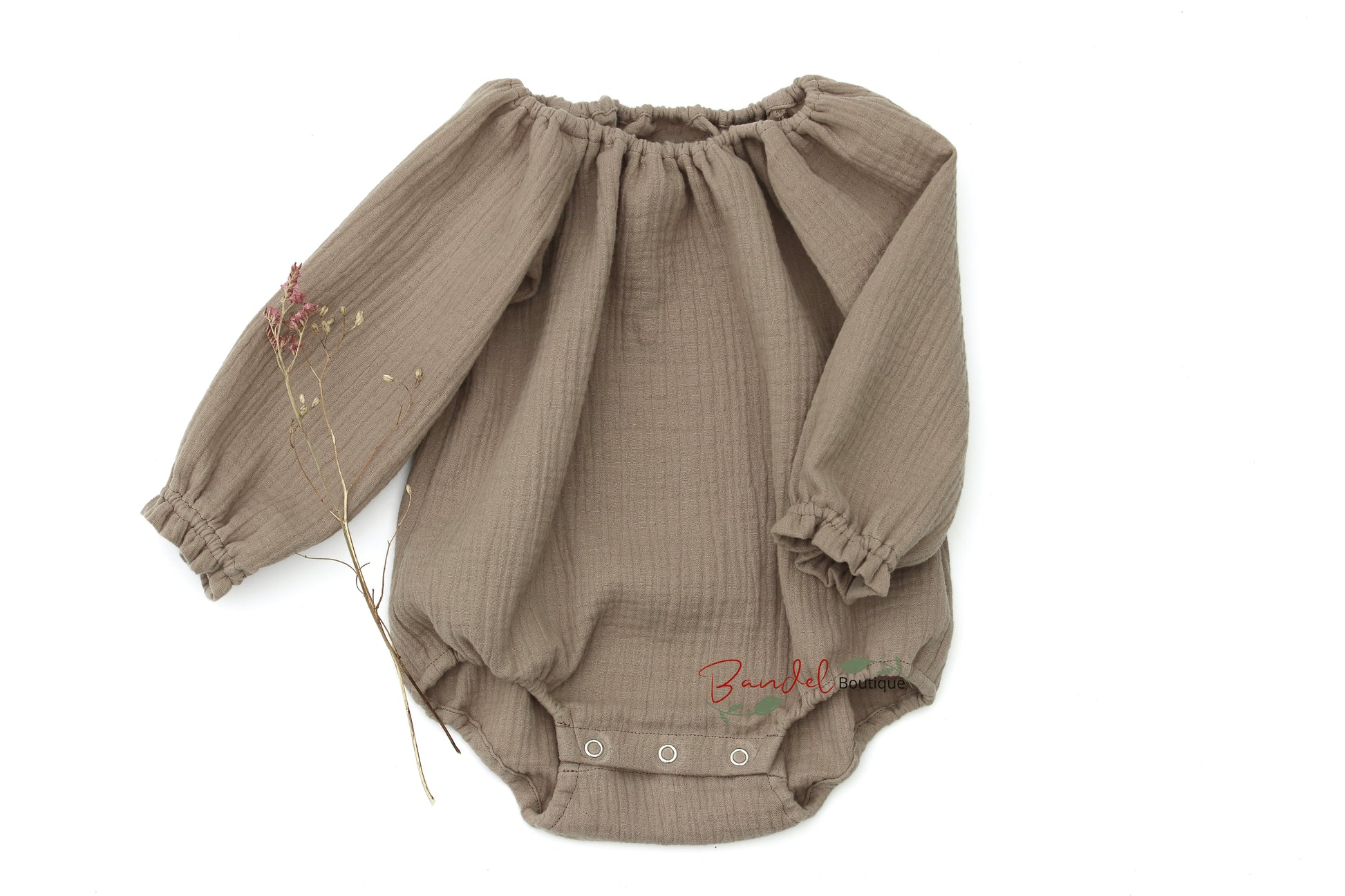 Handmade taupe- brown minimalist newborn baby romper with long sleeves, made from breathable and soft double gauze organic fabric. Features elasticized openings and crotch snaps for easy dressing and maximum comfort. 
