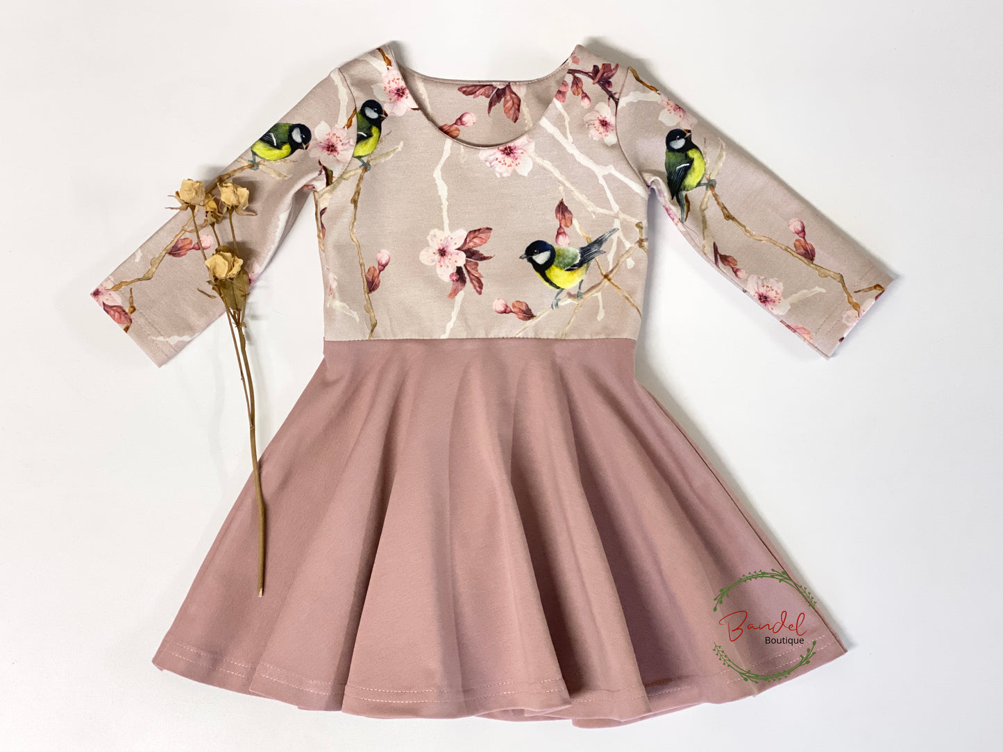 Blossom Bird Twirly dress is a timeless and elegant garment for your little girl. Crafted from comfortable jersey cotton, it features a slim fit with a vintage length that falls just above the knee. The bird blossom print and slim long sleeves will be the perfect finishing touches for any outfit.