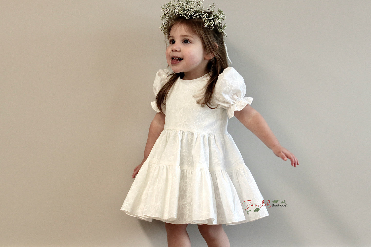 This Embroidery Ivory Dress is perfect for your little girl. Crafted from cotton fabric, it features a Simple bodice, Short puff sleeve, and a Two tiered gathered skirt with top tier being a gathered circle skirt. Secure it with the button back closure and your little girl is set to slay any occasion.