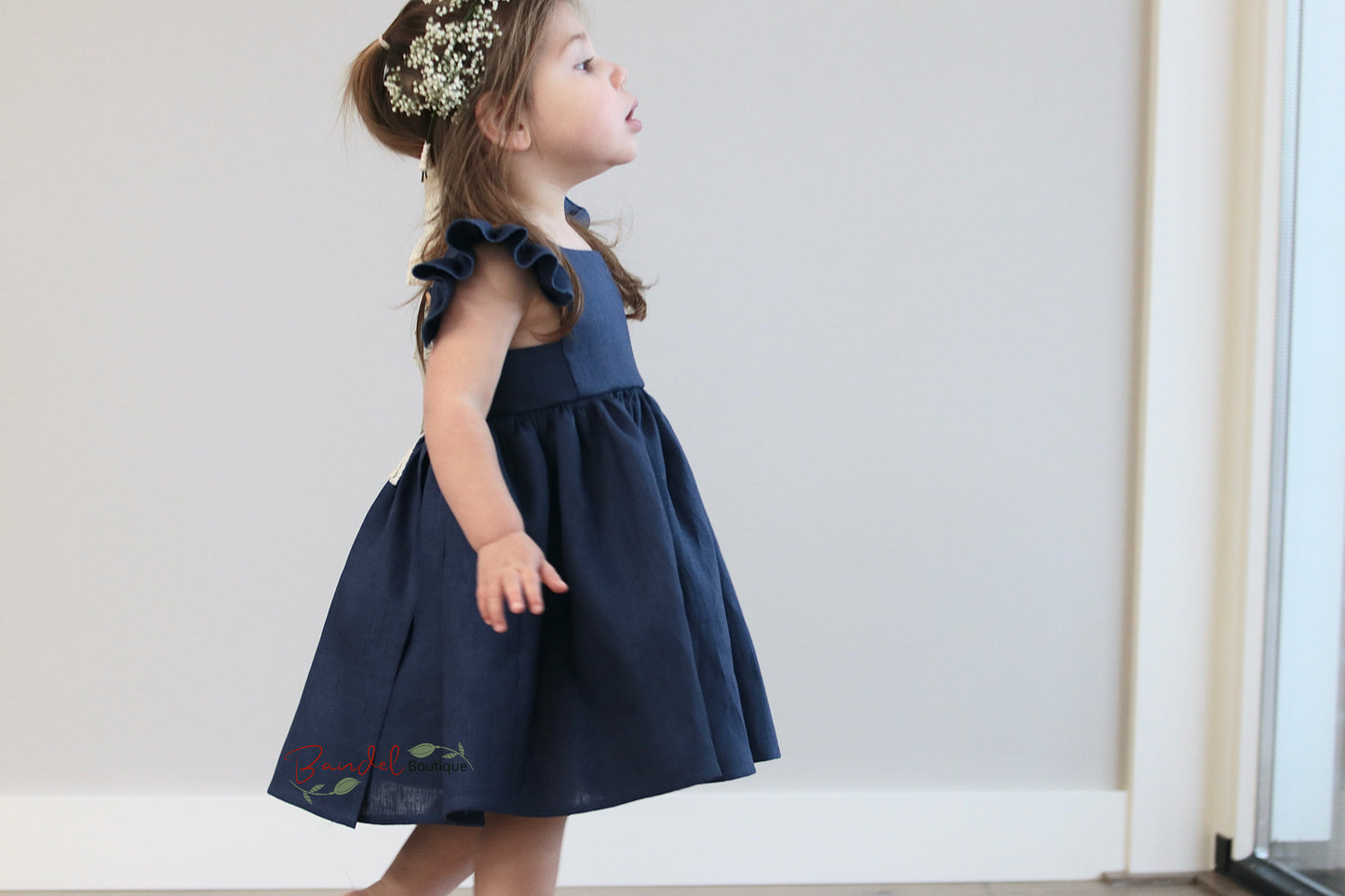 Royal Blue Girl Linen Dress is a stylish and comfortable choice for special occasions. Its light and breathable linen fabric is ideal for their warm weather wardrobe. Flutter sleeves, a square neckline and a playful ruffle hem add to the charming look while a double row of rustic wooden buttons complete the design.