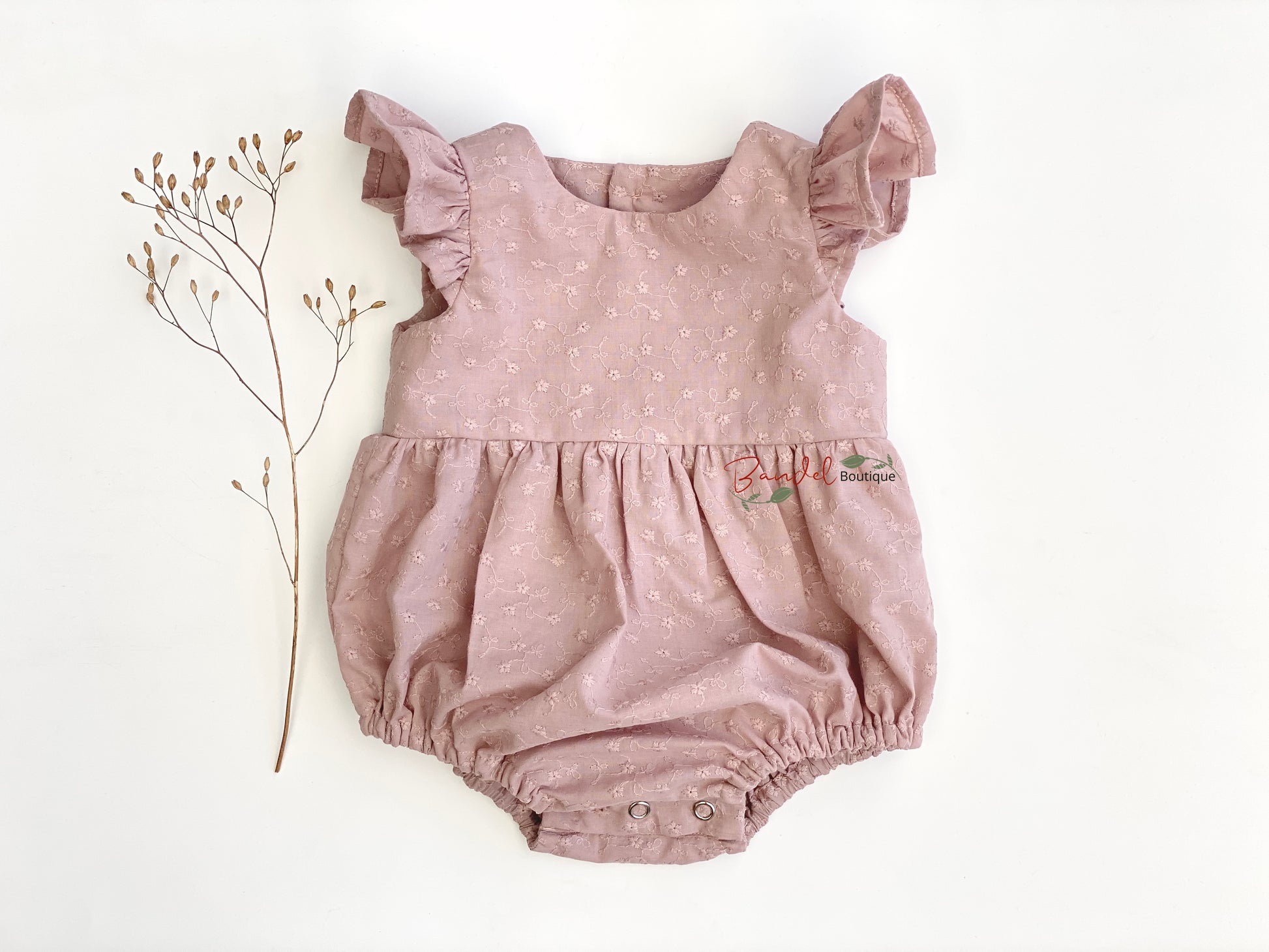 This adorable Flutter Sleeve Embroidery Romper is handmade in the Netherlands with beautiful old rose embroidery cotton. Features include flutter sleeves, elastic at the leg, wooden buttons at the back, and snaps at the crotch for easy changing. Perfect for those special occasions.