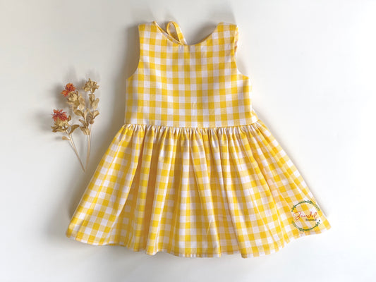 Yellow Check Dress is perfect for your little girl! Crafted from cotton, the dress features a comfortable, easy-fit bodice back with two rows of elastic and a large opening with a bow-tie detail. The knee-length dress is finished with a full skirt for a classic look.