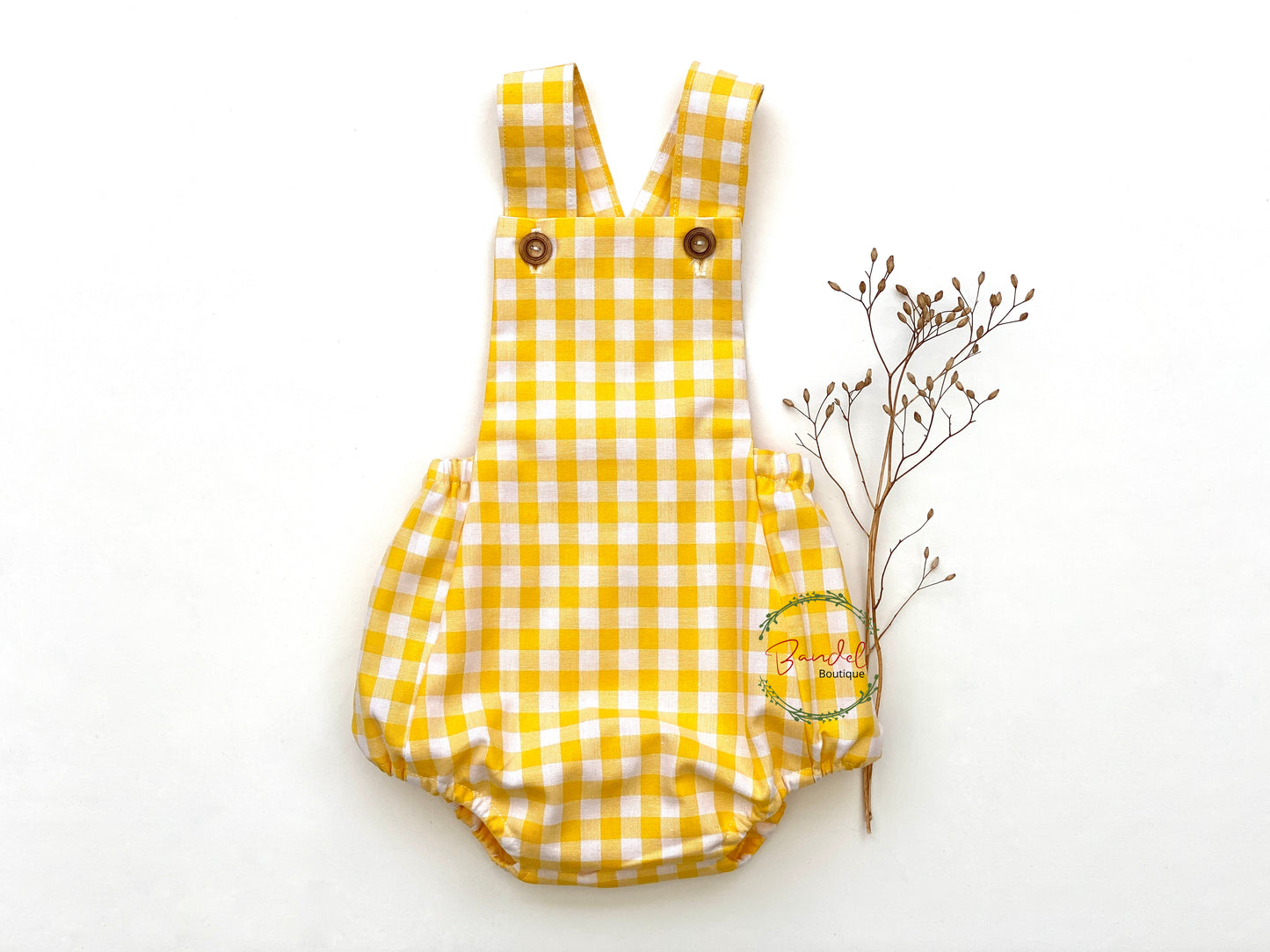 Yellow Check Cotton Romper is perfect for your little ones! Crafted from soft cotton, it is both comfortable and durable. The two shoulder straps with front wooden button closure provide a secure fit and an adorable look.