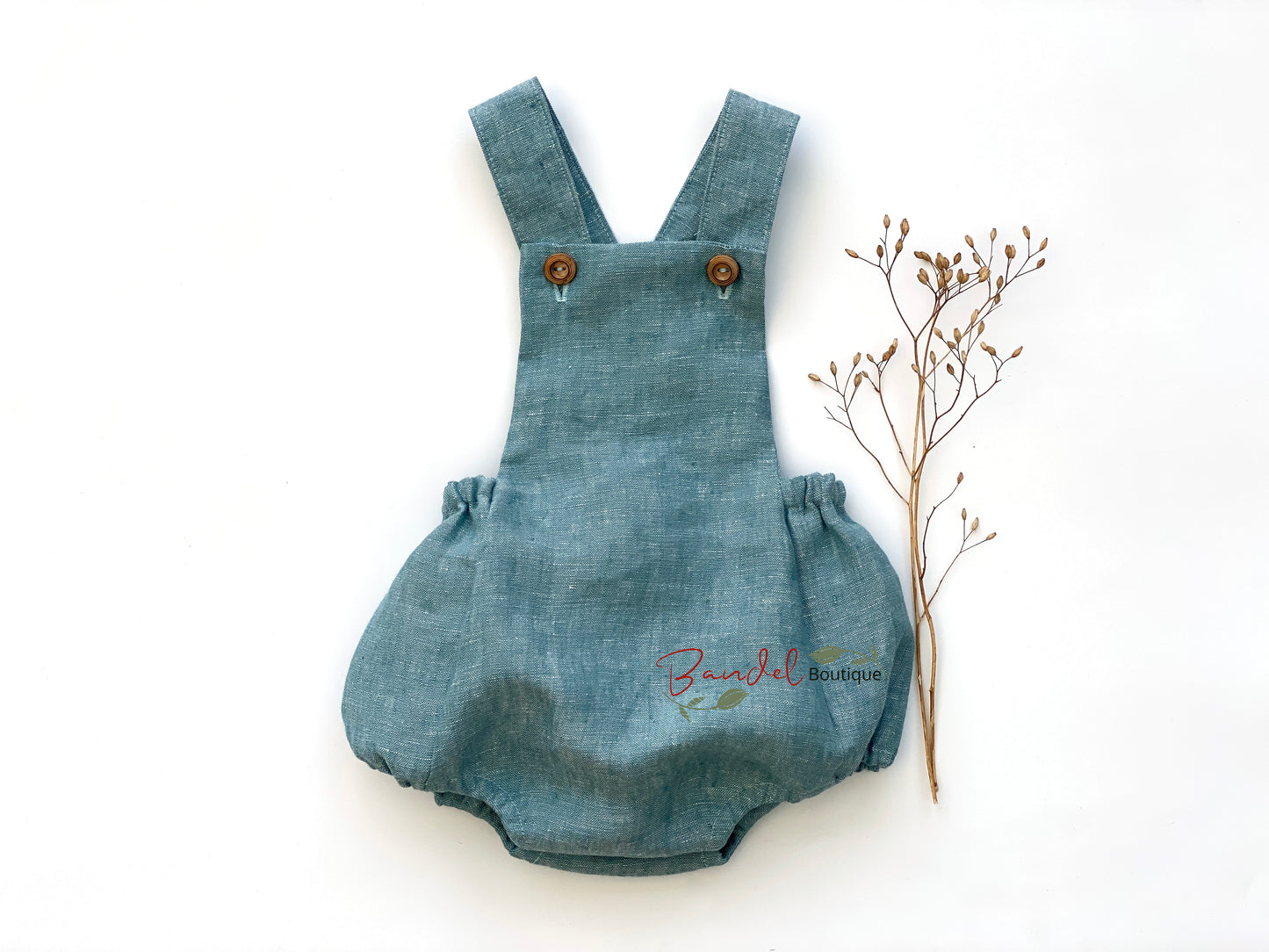 Mint Linen Baby Romper is the perfect eco-friendly addition to any baby's wardrobe. Crafted from sustainably-sourced linen and fastened with a stylish wooden button, this romper offers a comfortable fit, thanks to the elastic back waistband and leg openings. Perfect for playtime styling.