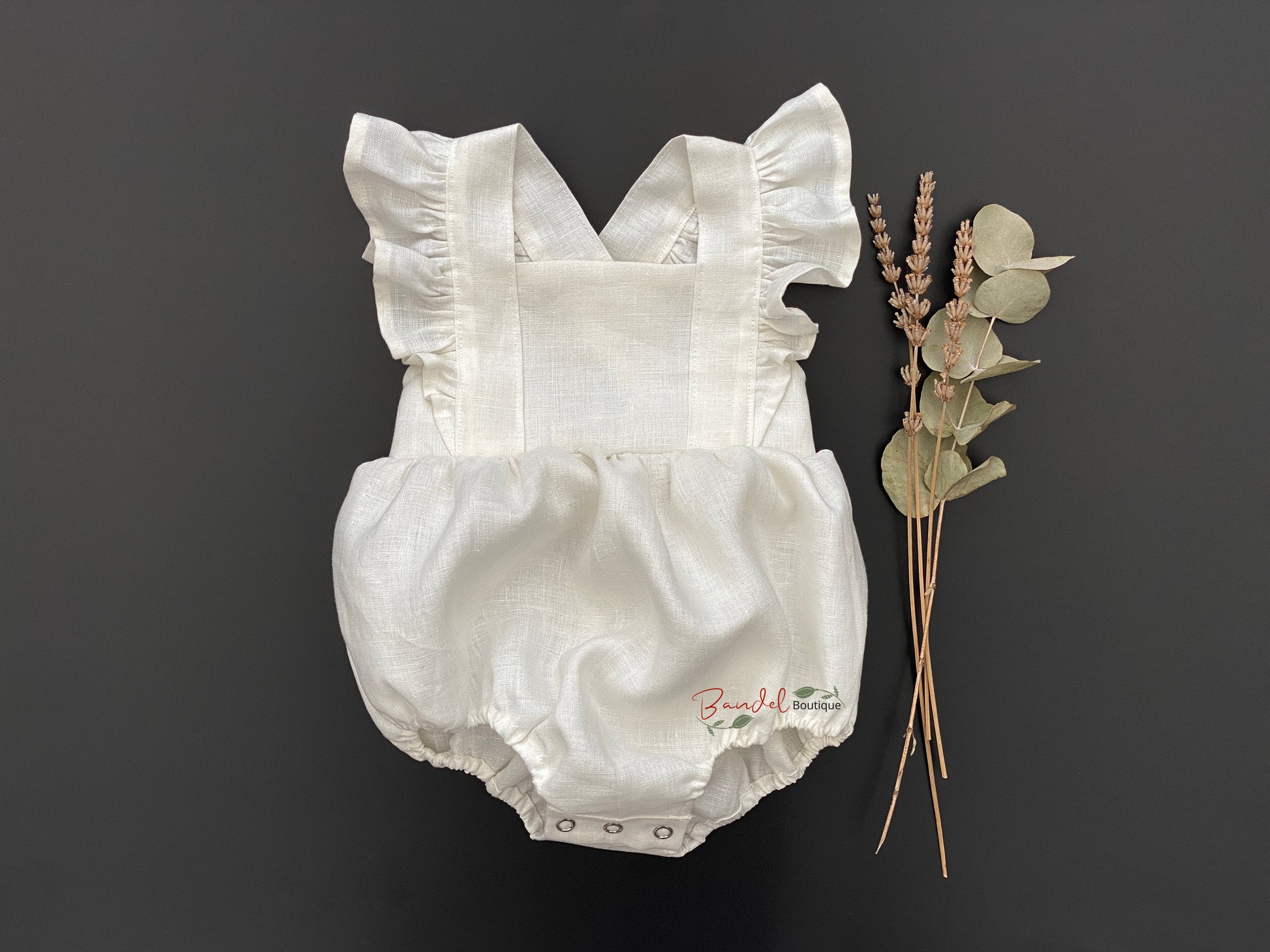 Bubble Romper-Ivory is made from 100% linen and features adjustable button straps, elastic at the leg, and snaps at the crotch for easy diaper changes. The Vintage Bubble Playsuit adds an extra special touch with its sleeve ruffles. Perfect for your little one to look fashionable and be comfortable.