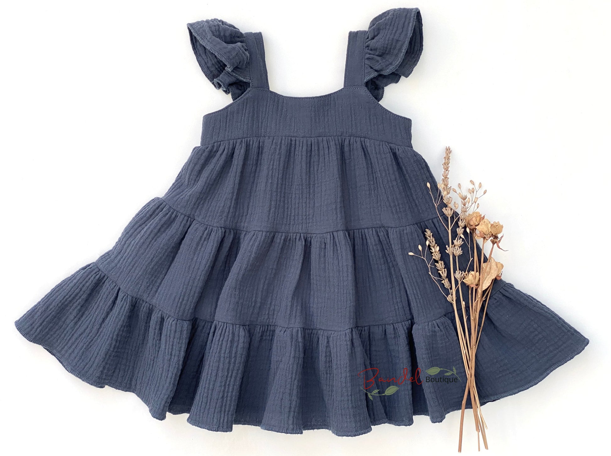 Jeans- Blue Dress is uniquely crafted from breathable muslin fabric. Featuring delicate flutter sleeves and gathered skirt adds extra charm. This Double Gauze Girl Dress offers a comfortable yet elegant look, making it the perfect choice for any special occasion.