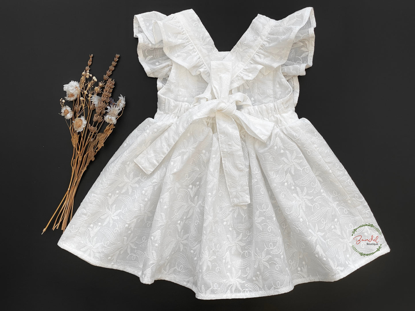 Embroidery Ivory Vintage dress is perfect for flower girls. It's made of cotton with an ivory hue and features exquisitely detailed embroidery, adjustable straps, ruffled sleeves, and a gathered skirt. The dress is sure to make your flower girl look beautiful on your special day.
