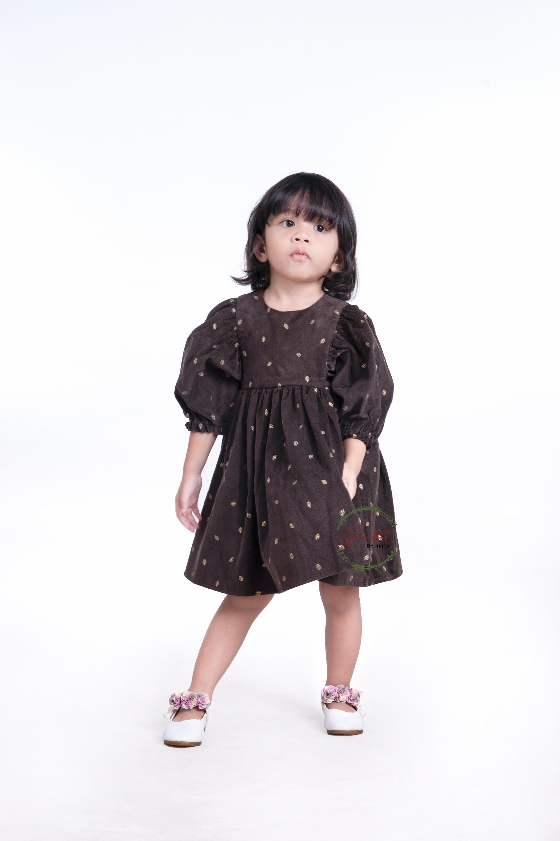3/4 Sleeves Corduroy Girl Dress Crafted with a luxurious corduroy fabric featuring gold leafs prints and classic styling, this whimsical dress is finished with a ruffled hem, 3/4 length sleeves, and a wooden button closure at the back bodice.