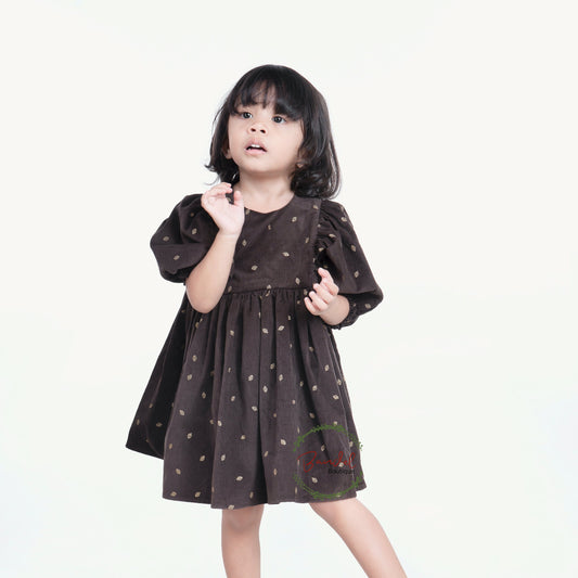 3/4 Sleeves Corduroy Girl Dress Crafted with a luxurious corduroy fabric featuring gold leafs prints and classic styling, this whimsical dress is finished with a ruffled hem, 3/4 length sleeves, and a wooden button closure at the back bodice.