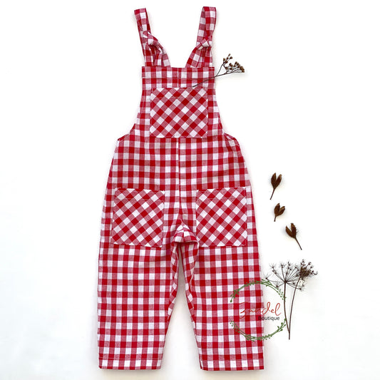 A timeless classic in the form of these Check Cotton Dungarees, crafted from comfortable red check cotton. A relaxed fit design with adjustable tie straps and 3 front pockets, allowing your little one to store small treasures with ease. Perfect for your little one's adventures. A sophisticated yet effortless piece, perfect for days spent outdoors.