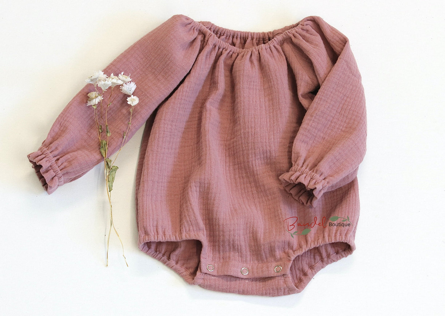 Handmade old- rose minimalist newborn baby romper with long sleeves, made from breathable and soft double gauze organic fabric. Features elasticized openings and crotch snaps for easy dressing and maximum comfort. 