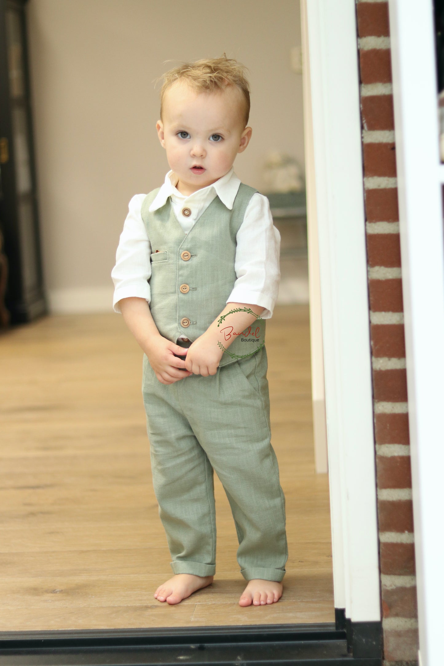 classic and timeless linen ring bearer outfit in eucalypts color is the perfect choice for special occasions. It's paired with an ivory linen shirt for an elegant yet comfortable look. Create lasting memories with this beautiful ensemble.